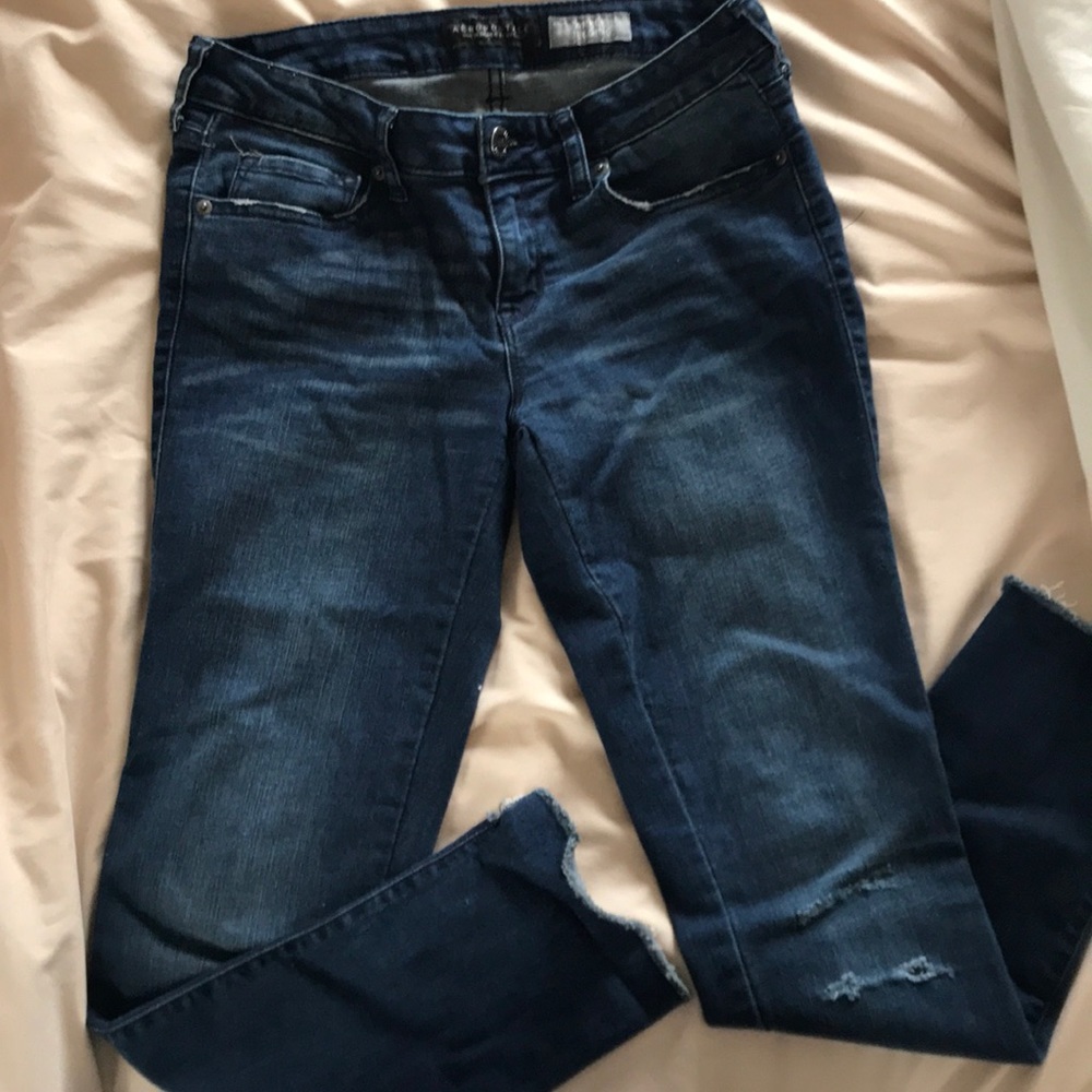 Dark blue distressed jeans